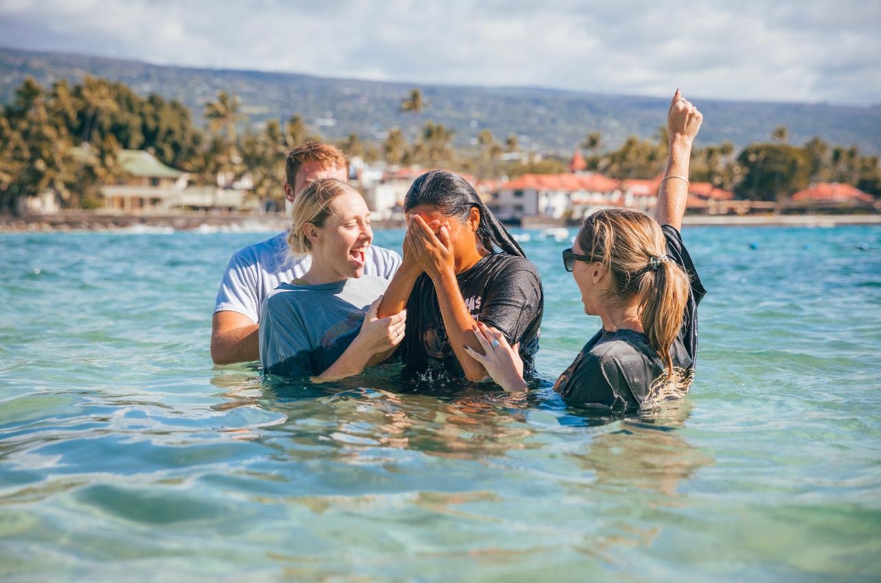Belle Liu embraced by friends moments after coming up out of the water